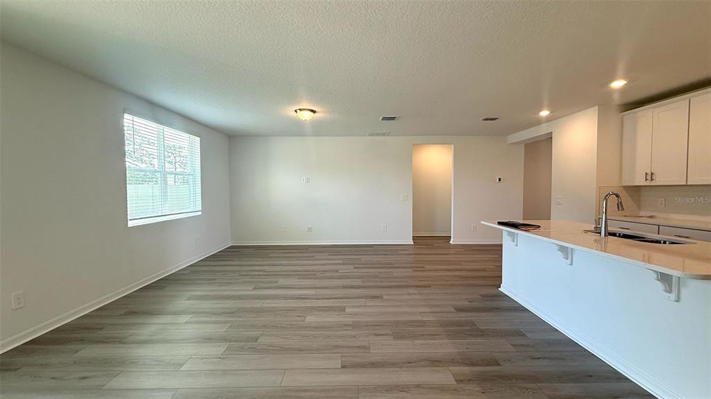 4543 Sidesaddle Trail St. Cloud, FL 34772 - Photo 6 of 19 a view of kitchen with sink and wooden floor