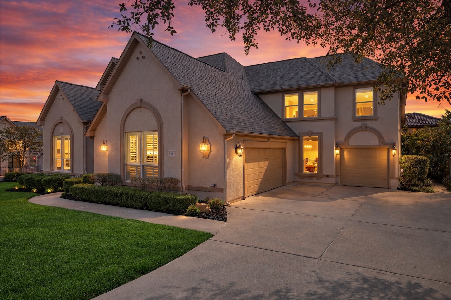 a view of a house with a large windows and a yard