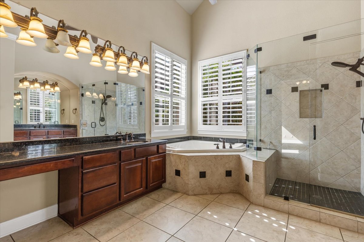 111 Whitley Drive Austin, TX 78738 - Photo 22 of 38 a spacious bathroom with a granite countertop tub sink and mirror