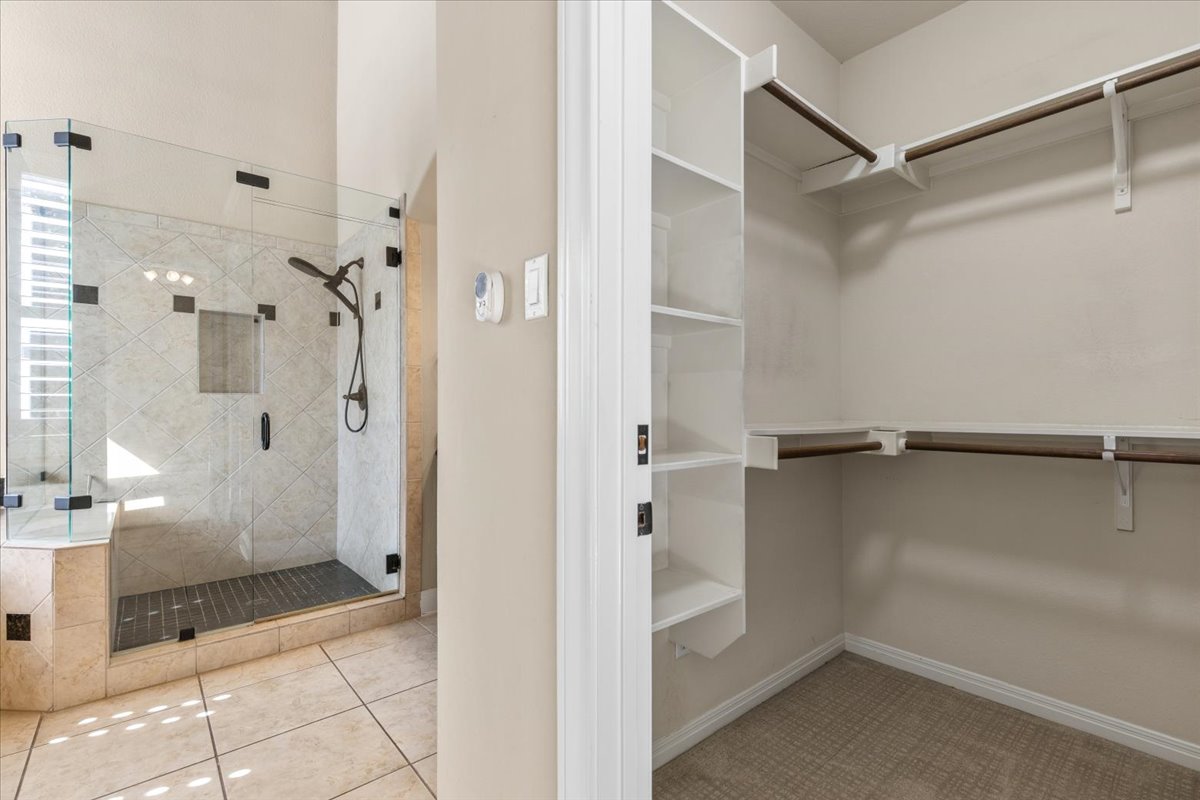 111 Whitley Drive Austin, TX 78738 - Photo 24 of 38 a bathroom with a glass shower door