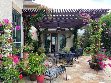 a view of a patio with table and chairs and potted plants