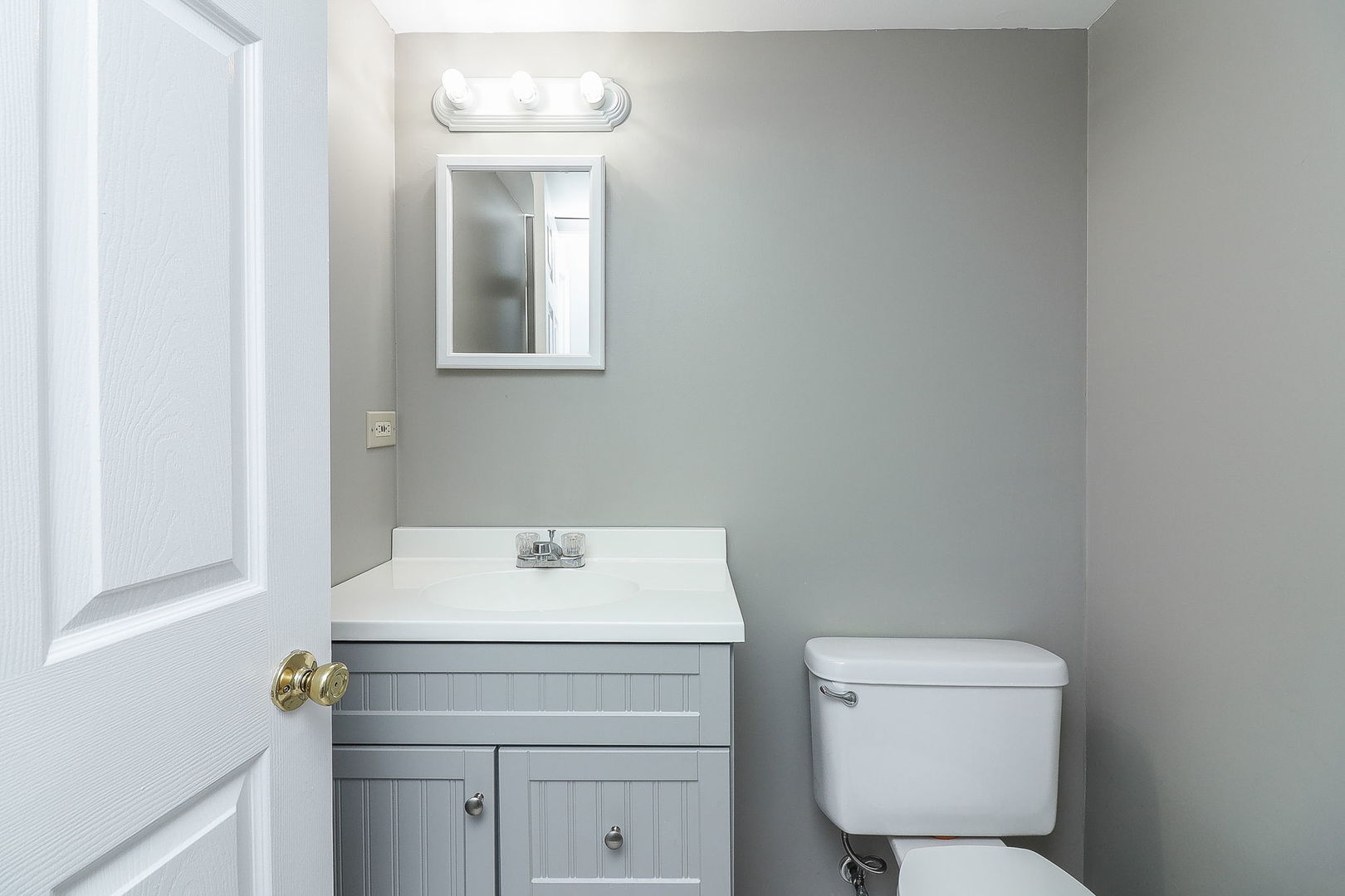 307 Cedarbrook Road Naperville, IL 60565 - Photo 13 of 25 a bathroom with a toilet sink vanity and mirror