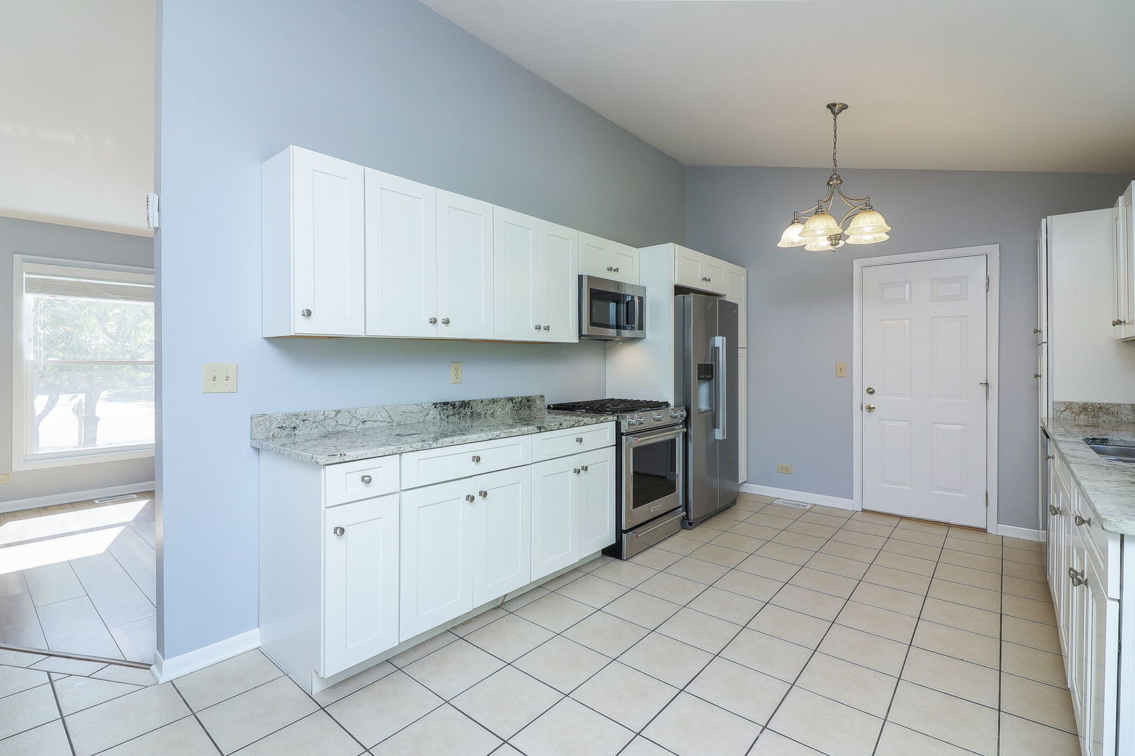307 Cedarbrook Road Naperville, IL 60565 - Photo 5 of 25 a kitchen with granite countertop a sink cabinets and stainless steel appliances