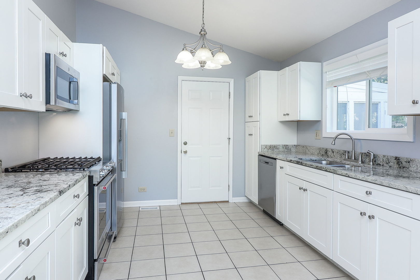 307 Cedarbrook Road Naperville, IL 60565 - Photo 6 of 25 a kitchen with granite countertop a sink stove and cabinets