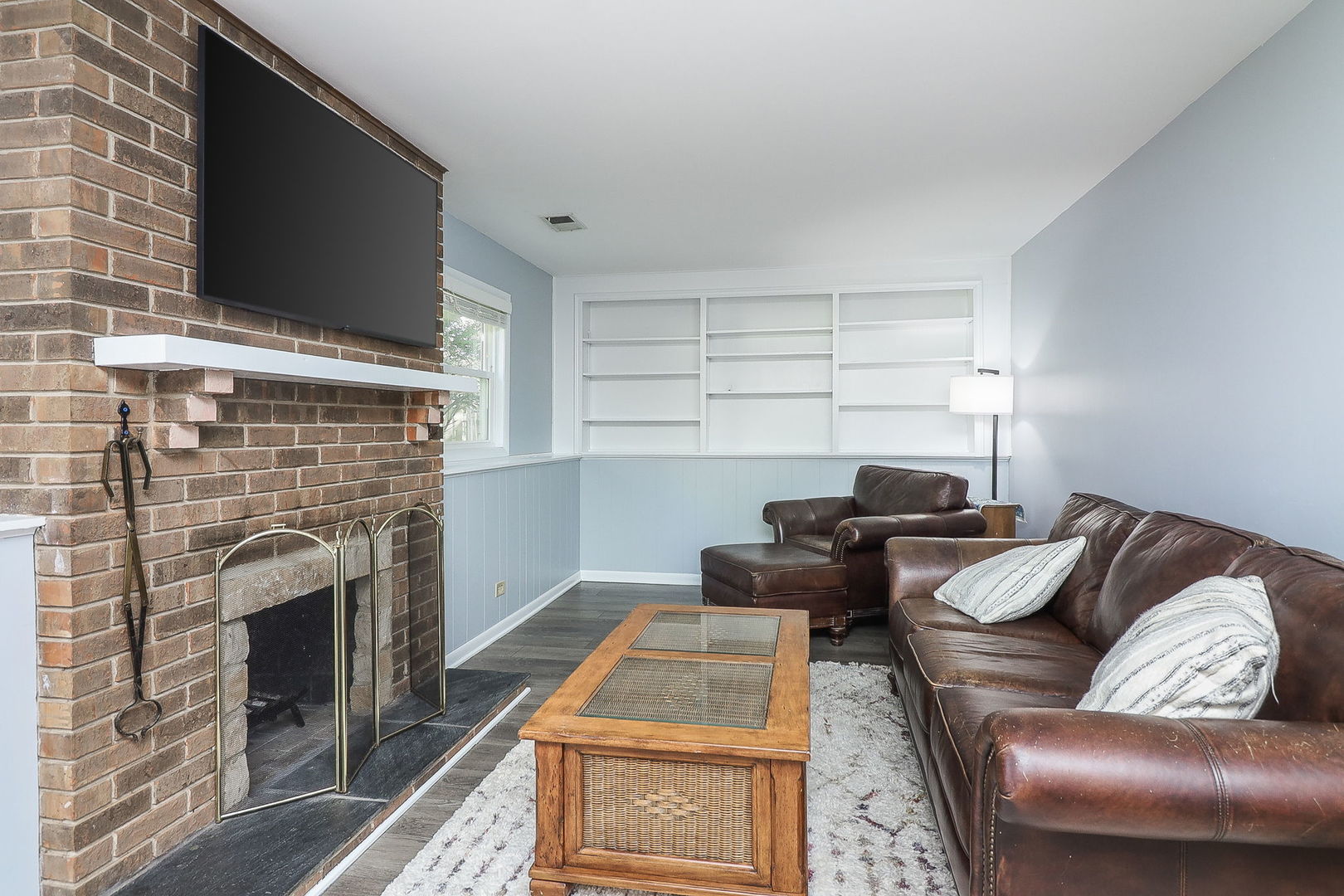 307 Cedarbrook Road Naperville, IL 60565 - Photo 9 of 25 a living room with furniture a flat screen tv and a fireplace