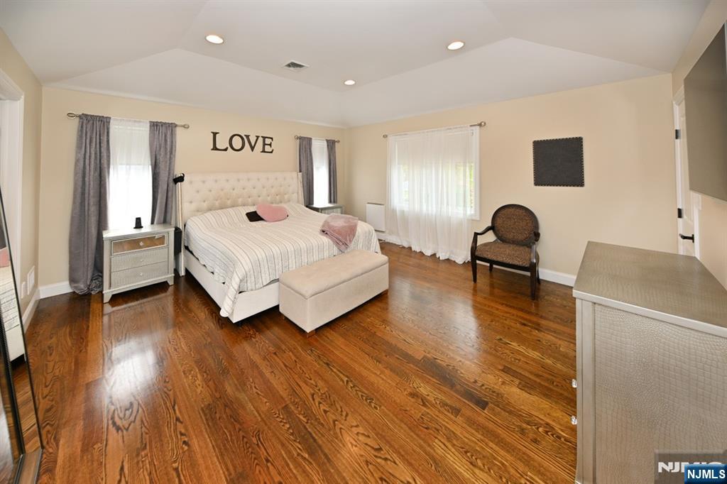 106 Arnot Place Paramus, NJ 07652 - Photo 20 of 48 a bedroom with a bed and wooden floor