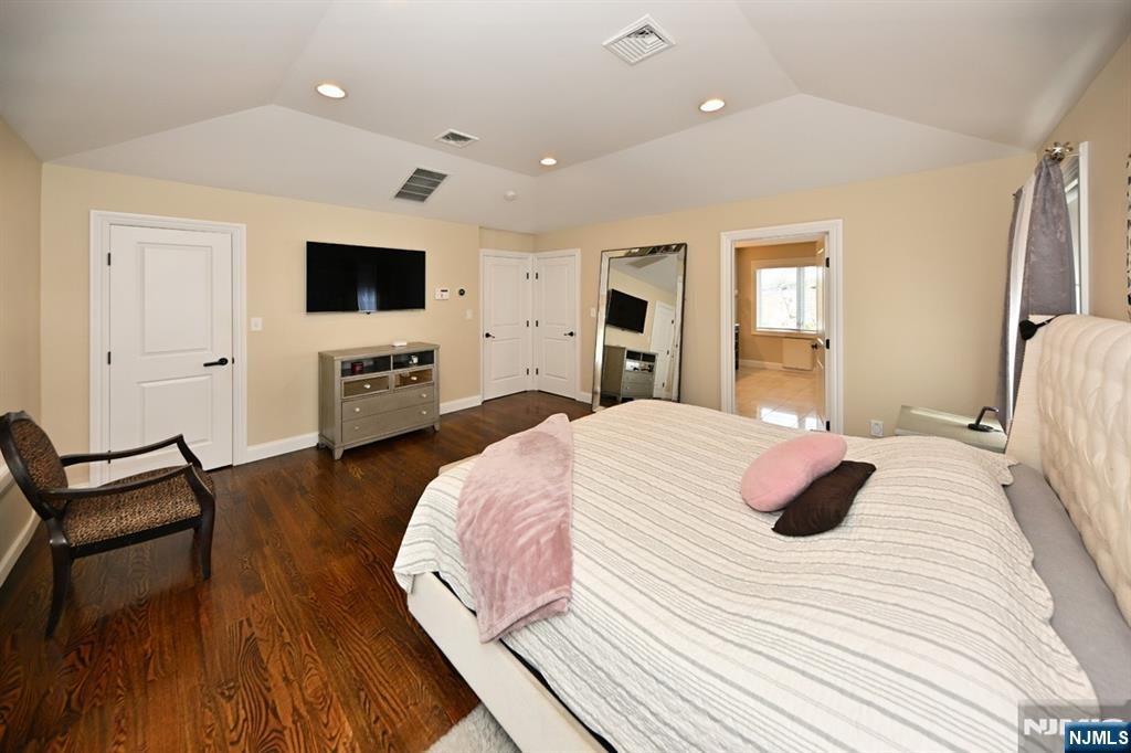 106 Arnot Place Paramus, NJ 07652 - Photo 21 of 48 a bedroom with a bed and a flat screen tv