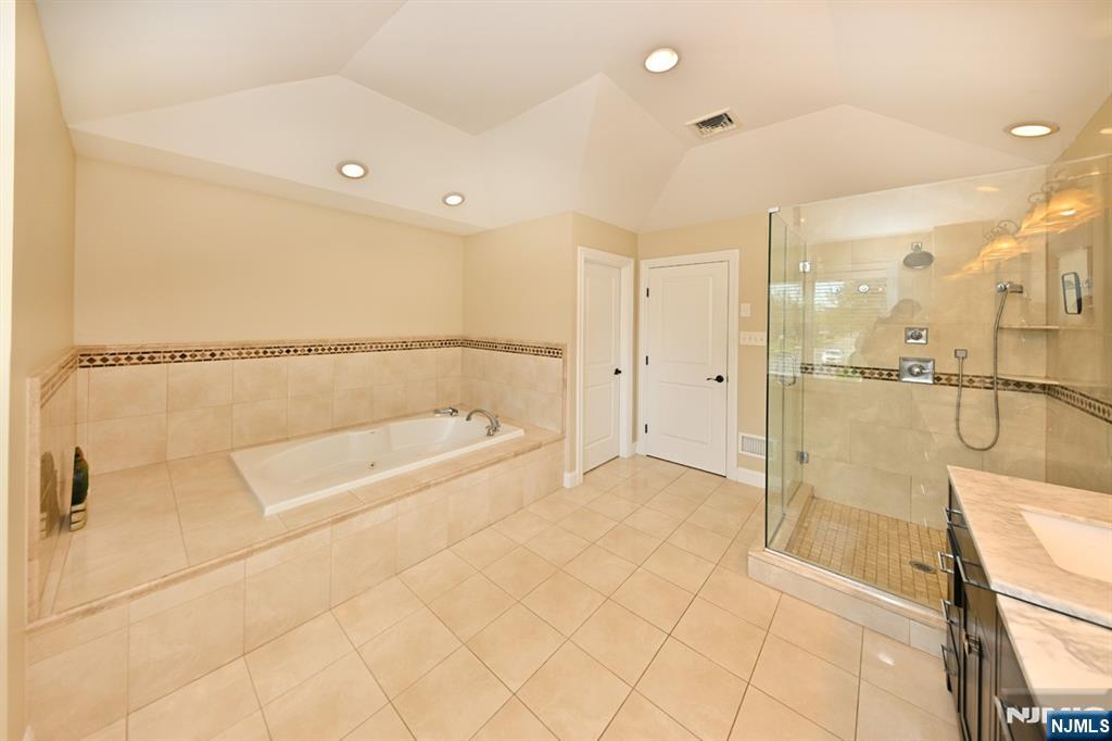106 Arnot Place Paramus, NJ 07652 - Photo 22 of 48 a bathroom with a bathtub and a shower
