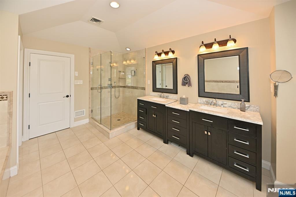 106 Arnot Place Paramus, NJ 07652 - Photo 23 of 48 a spacious bathroom with a granite countertop sink mirror and double