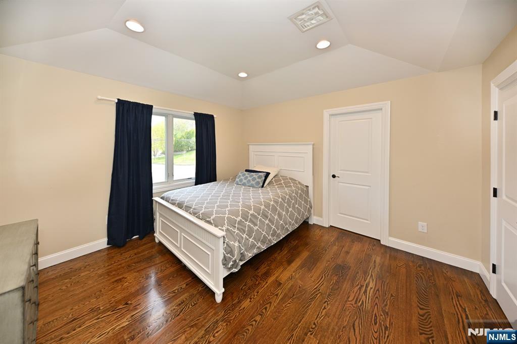 106 Arnot Place Paramus, NJ 07652 - Photo 24 of 48 a bedroom with a bed and wooden floor