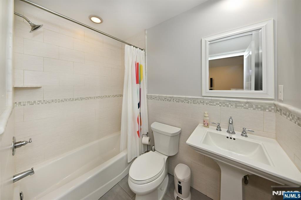 106 Arnot Place Paramus, NJ 07652 - Photo 25 of 48 a bathroom with a sink toilet and shower