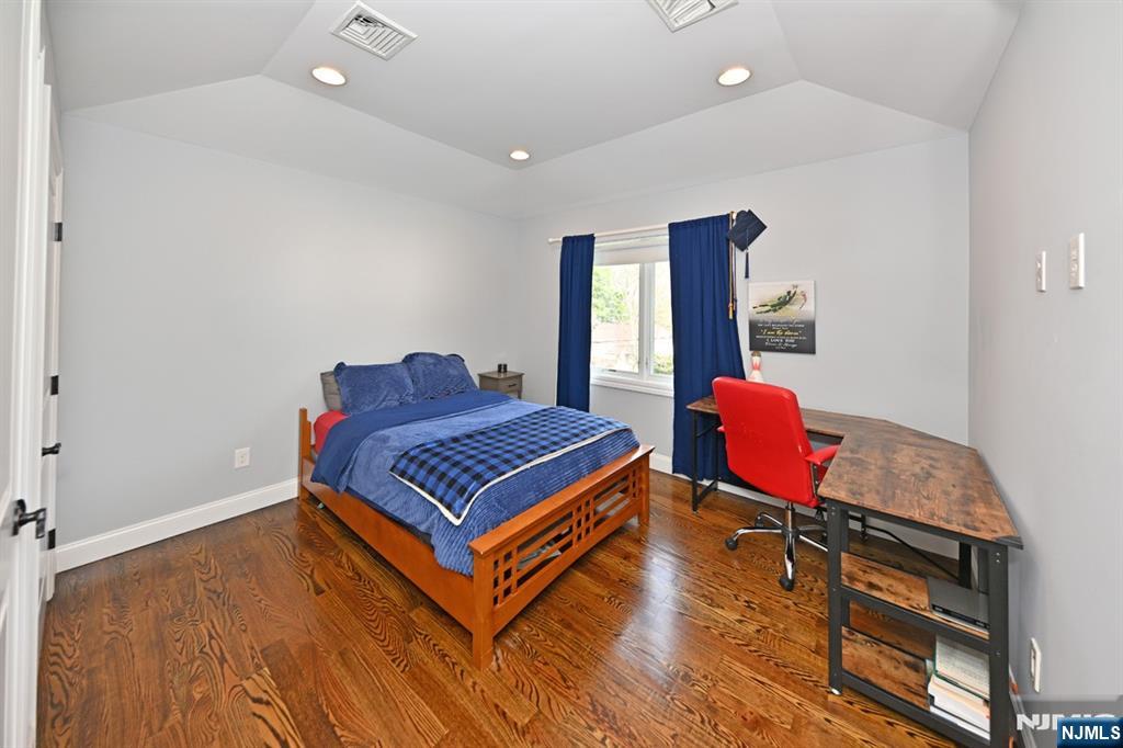106 Arnot Place Paramus, NJ 07652 - Photo 26 of 48 a room with a bed and wooden floor