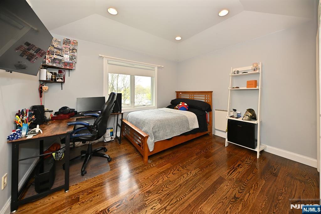106 Arnot Place Paramus, NJ 07652 - Photo 27 of 48 a bedroom with furniture and a wooden floor