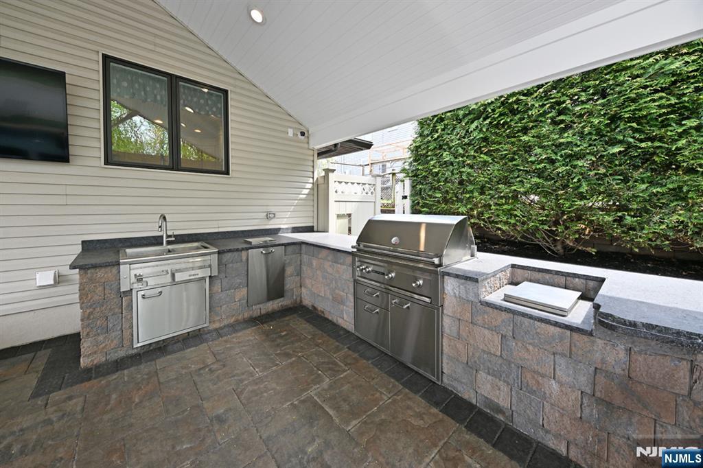 106 Arnot Place Paramus, NJ 07652 - Photo 37 of 48 a kitchen with sink cabinets and stove
