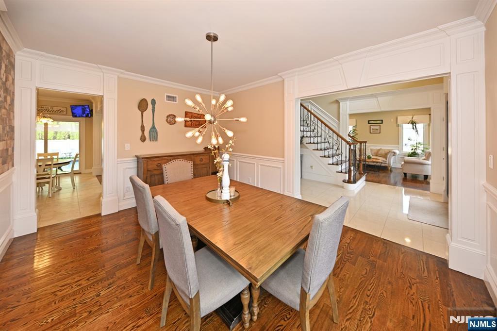 106 Arnot Place Paramus, NJ 07652 - Photo 6 of 48 a view of a dining room with furniture and wooden floor
