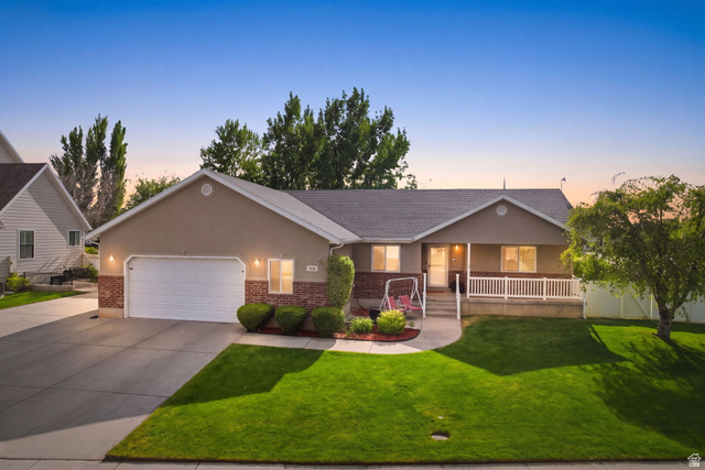 1816 River Bottom Road Springville, UT 84663 - Photo 1 of 37 Single-story residence featuring a two-car garage, partial brick facade, and a covered front porch with white railing