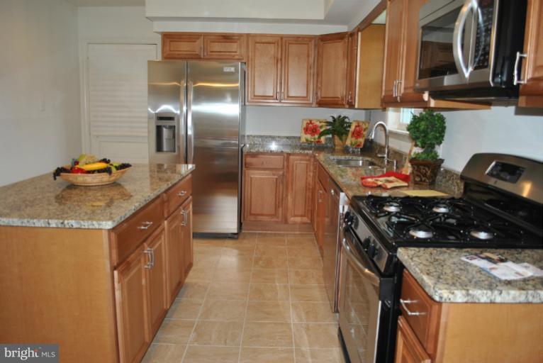 19516 Olney Mill Road Olney, MD 20832 - Photo 11 of 29 a kitchen with stainless steel appliances granite countertop a sink stove and refrigerator