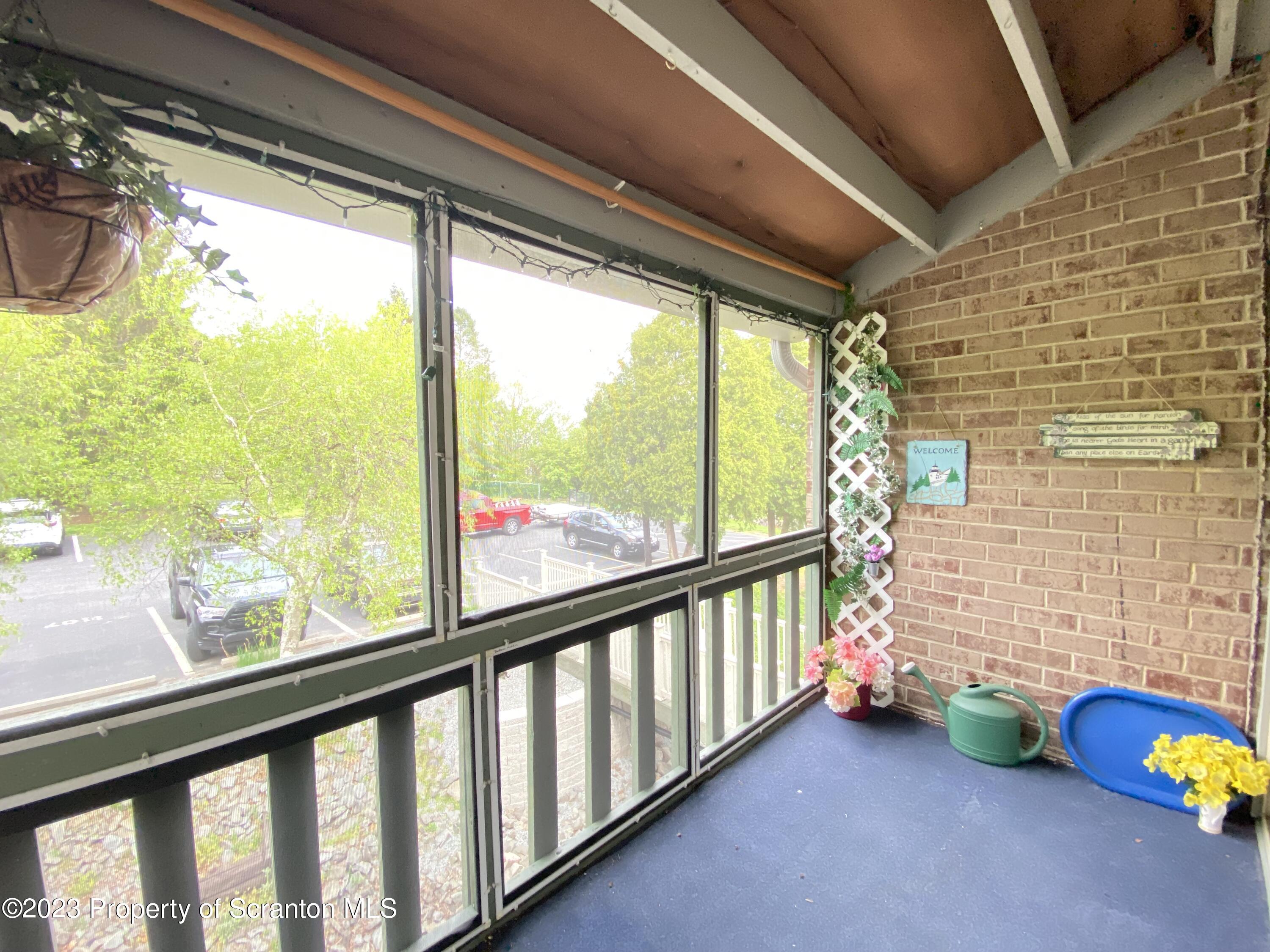 1112 Summit Pointe Scranton, PA 18508 - Photo 16 of 29 a view of a porch with a table and chairs
