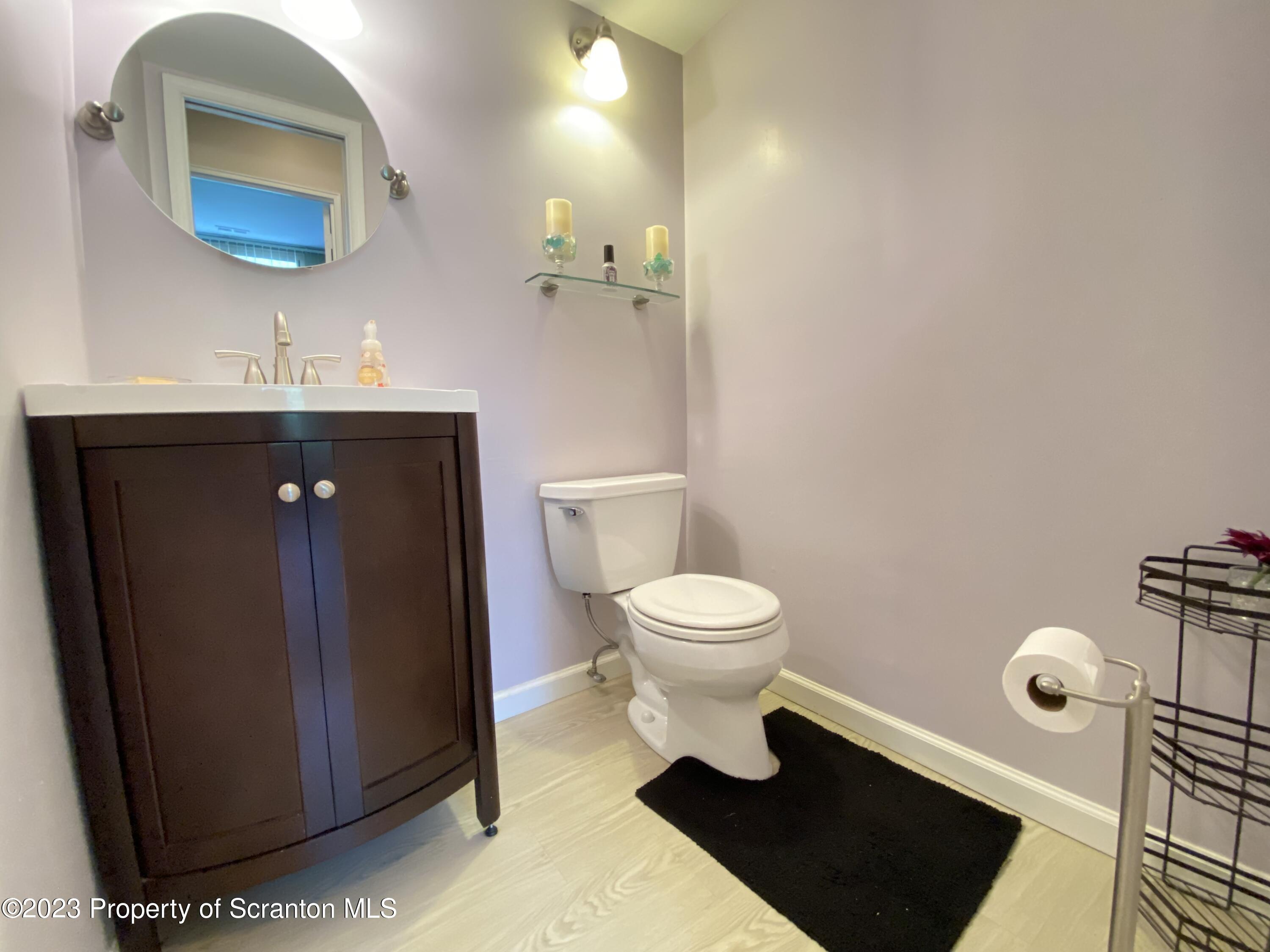 1112 Summit Pointe Scranton, PA 18508 - Photo 19 of 29 a bathroom with a toilet sink and mirror