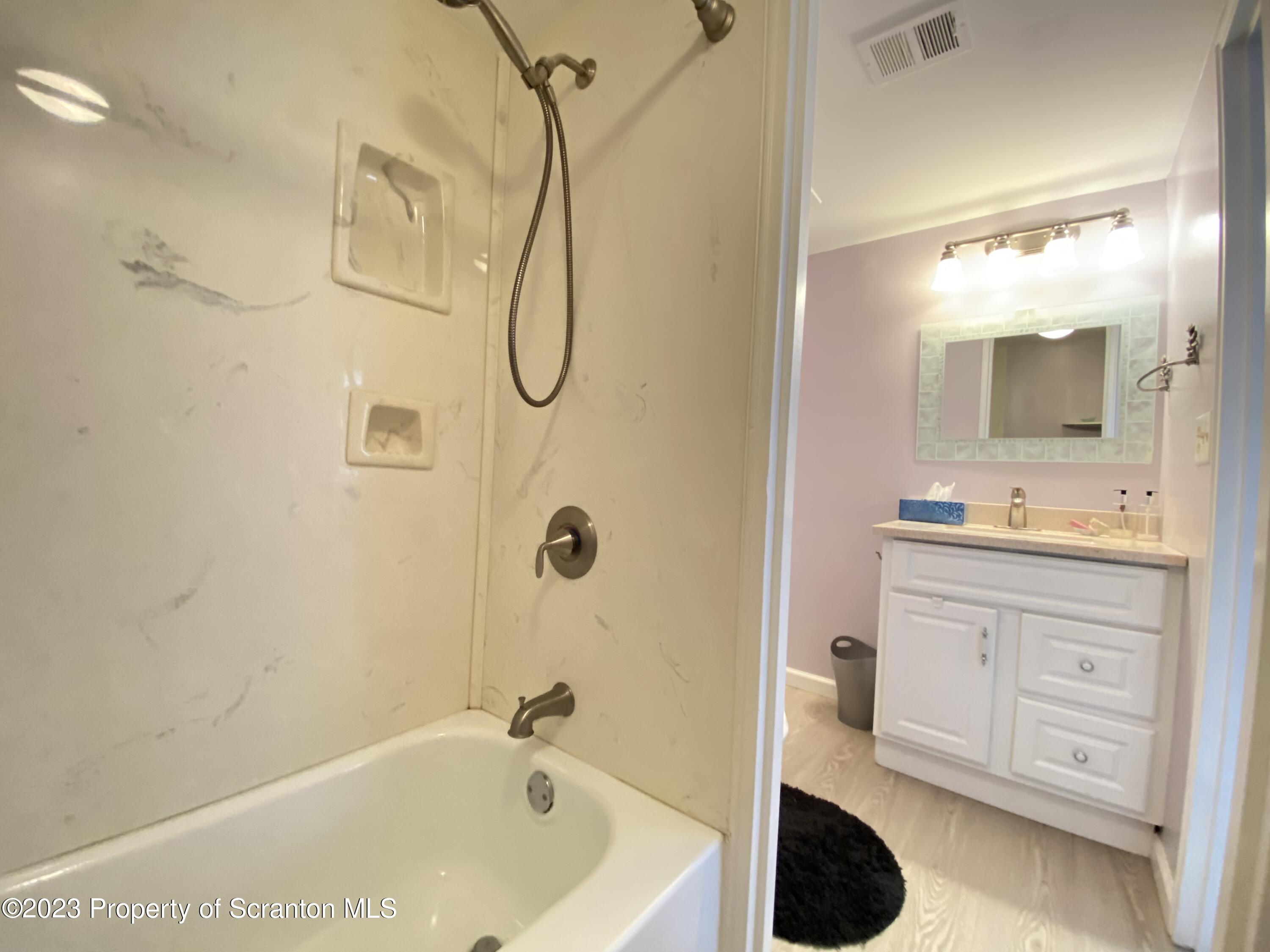 1112 Summit Pointe Scranton, PA 18508 - Photo 21 of 29 a bathroom with a granite countertop sink a mirror and shower