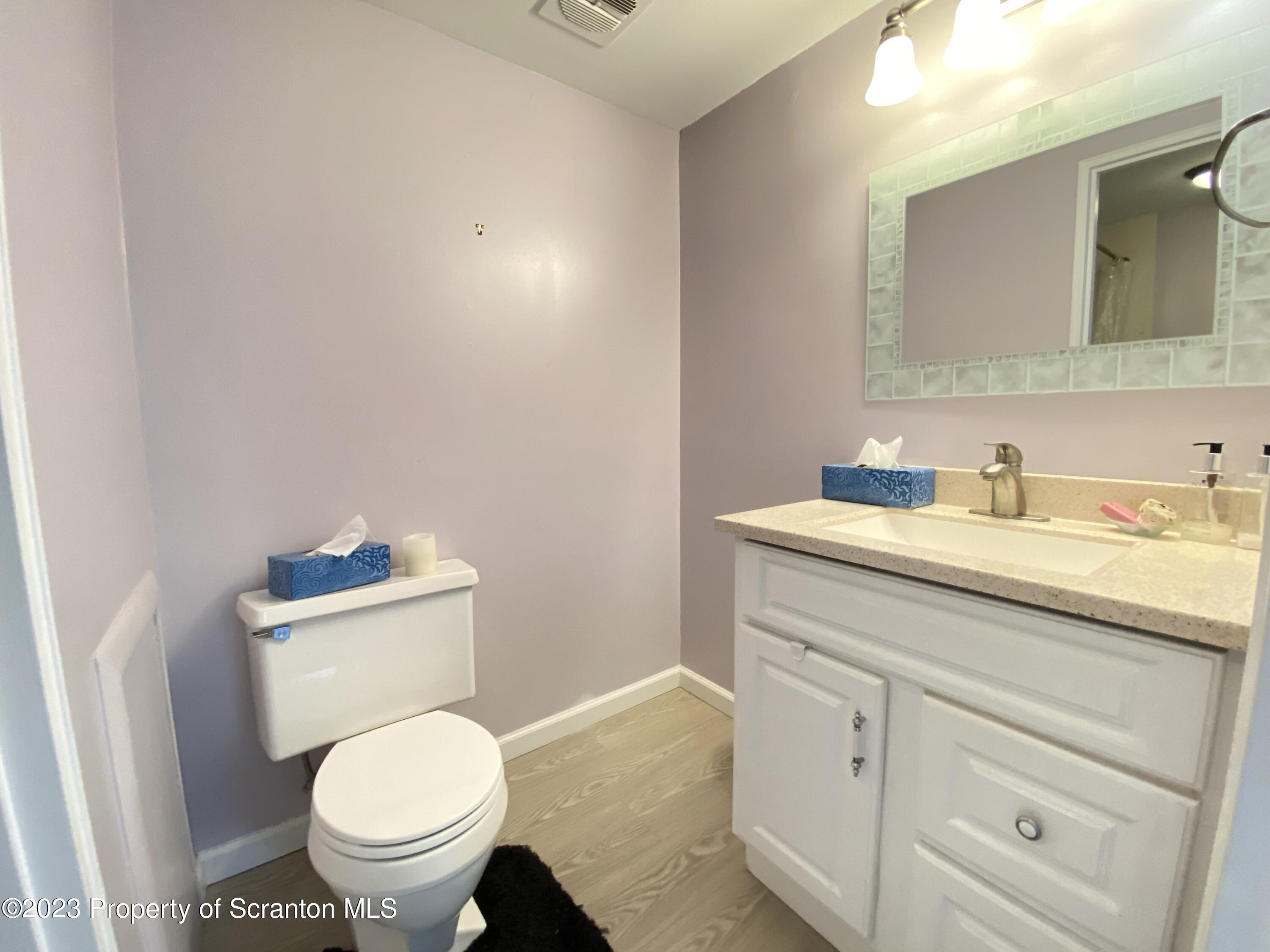 1112 Summit Pointe Scranton, PA 18508 - Photo 22 of 29 a bathroom with a toilet sink vanity and mirror