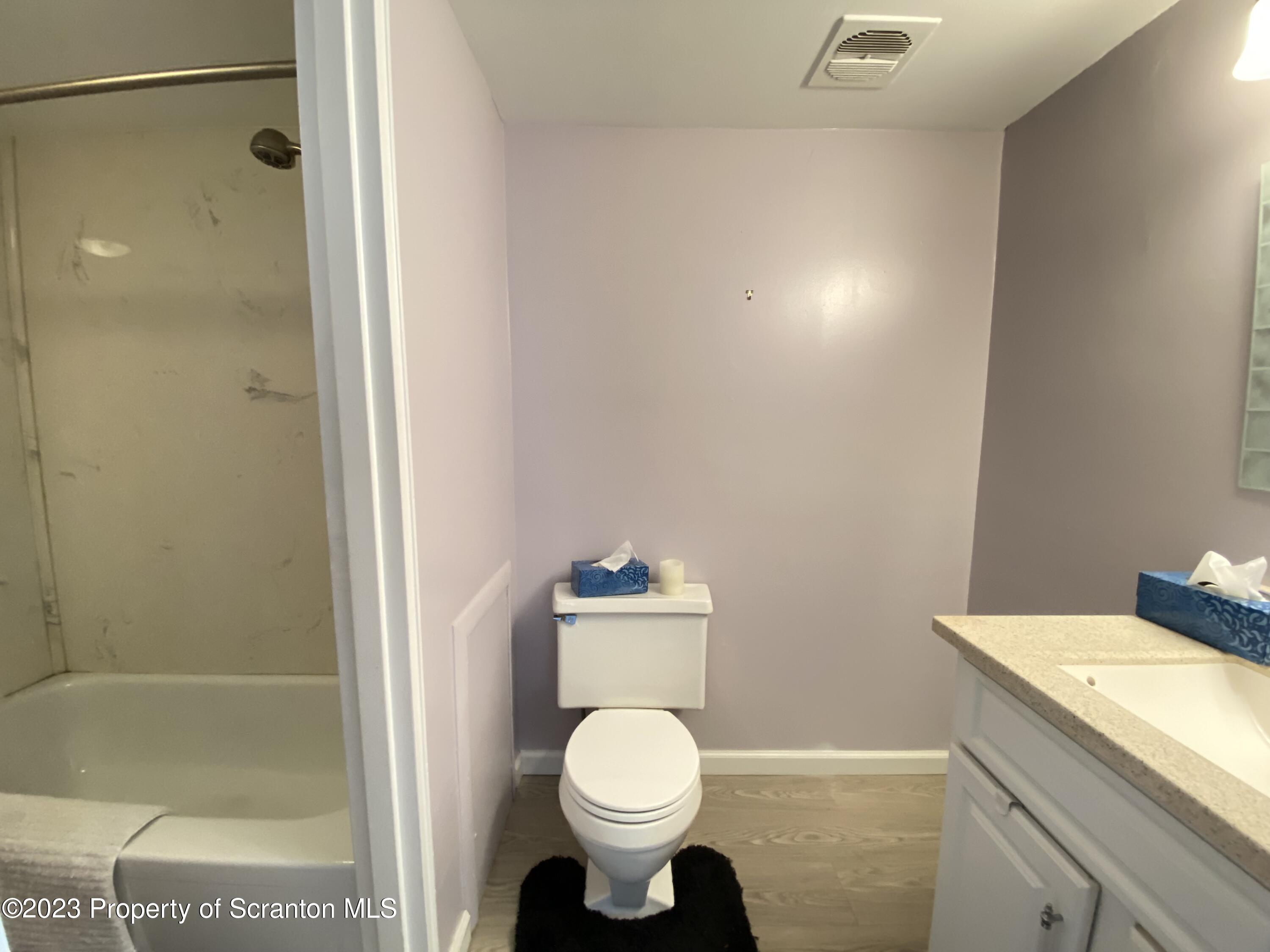 1112 Summit Pointe Scranton, PA 18508 - Photo 23 of 29 a white toilet sitting next to a bathroom sink and vanity