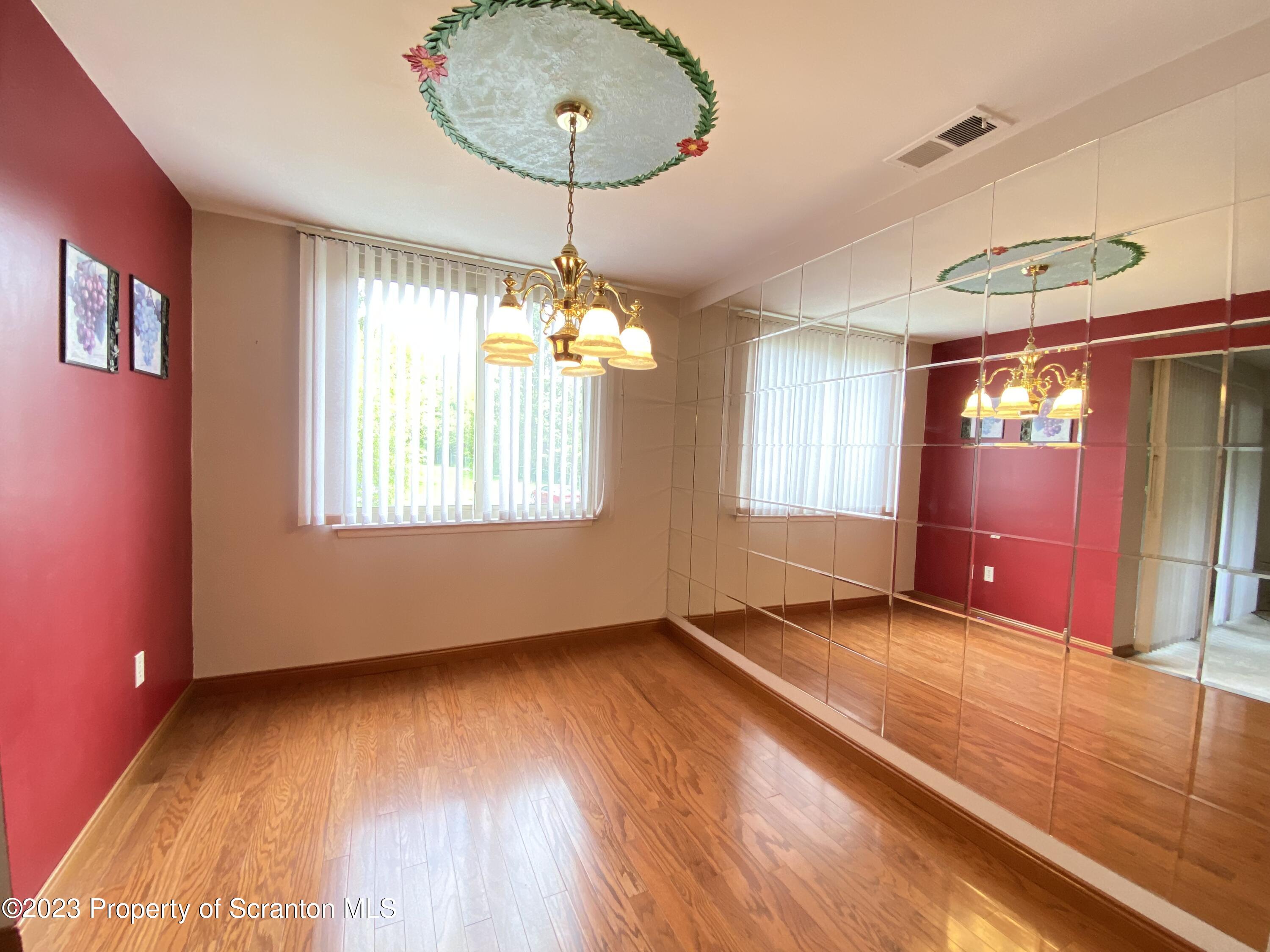 1112 Summit Pointe Scranton, PA 18508 - Photo 6 of 29 a view of an empty room with window and wooden floor