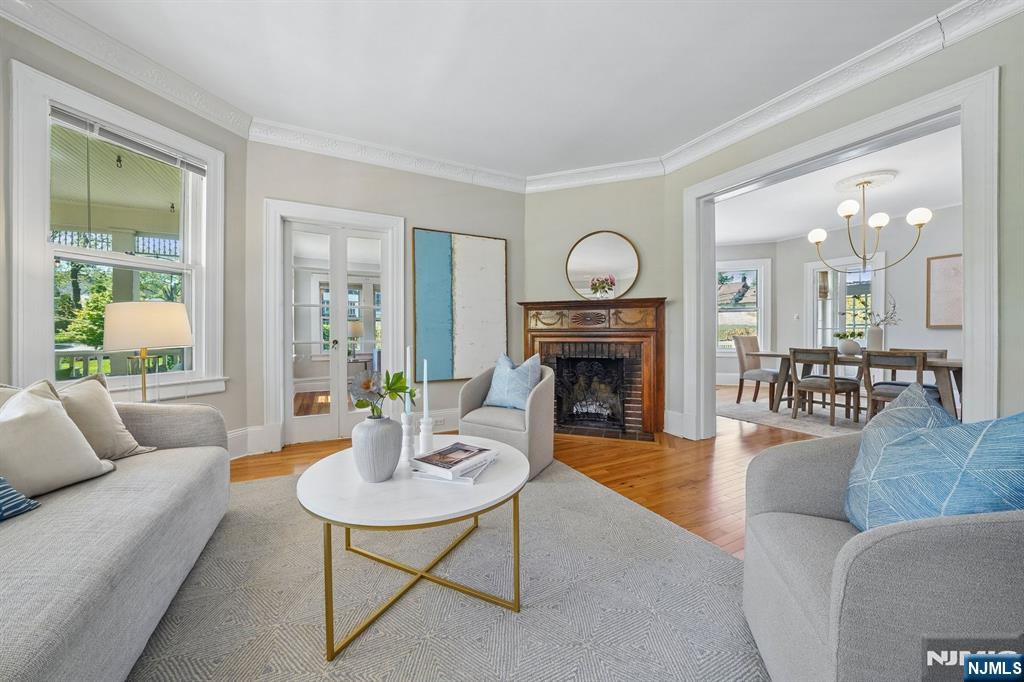 215 Inwood Avenue Montclair, NJ 07043 - Photo 11 of 50 a living room with furniture a fireplace a rug and a large window