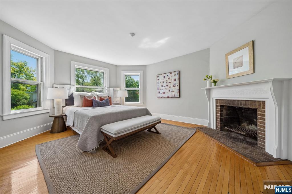215 Inwood Avenue Montclair, NJ 07043 - Photo 29 of 50 a bedroom with a bed and a fireplace