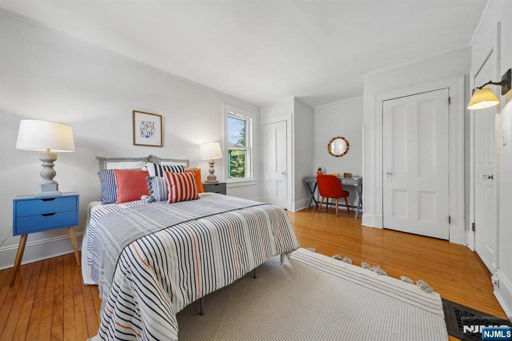 215 Inwood Avenue Montclair, NJ 07043 - Photo 35 of 50 a bed room with a bed and a lamp