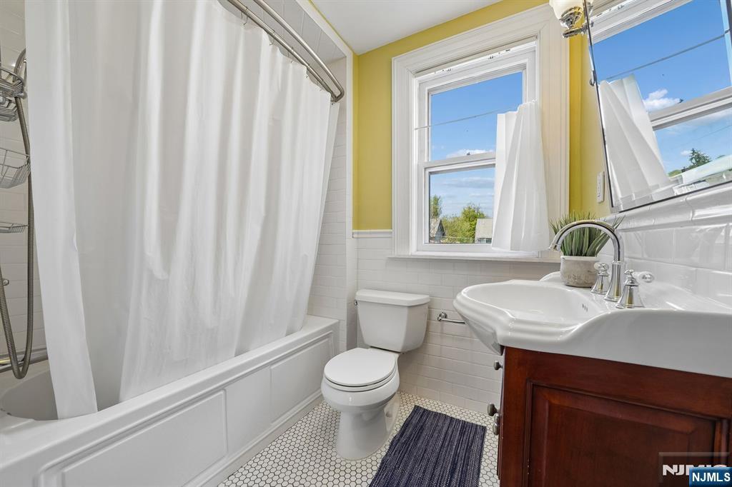 215 Inwood Avenue Montclair, NJ 07043 - Photo 36 of 50 a bathroom with a sink a toilet and a window