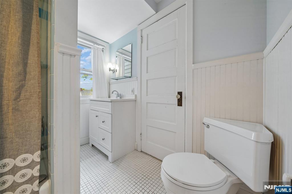 215 Inwood Avenue Montclair, NJ 07043 - Photo 38 of 50 a bathroom with a toilet a sink and a mirror