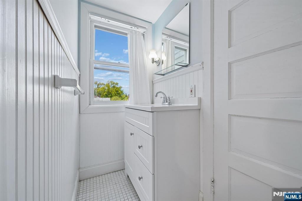215 Inwood Avenue Montclair, NJ 07043 - Photo 39 of 50 a bathroom with a sink a mirror and vanity