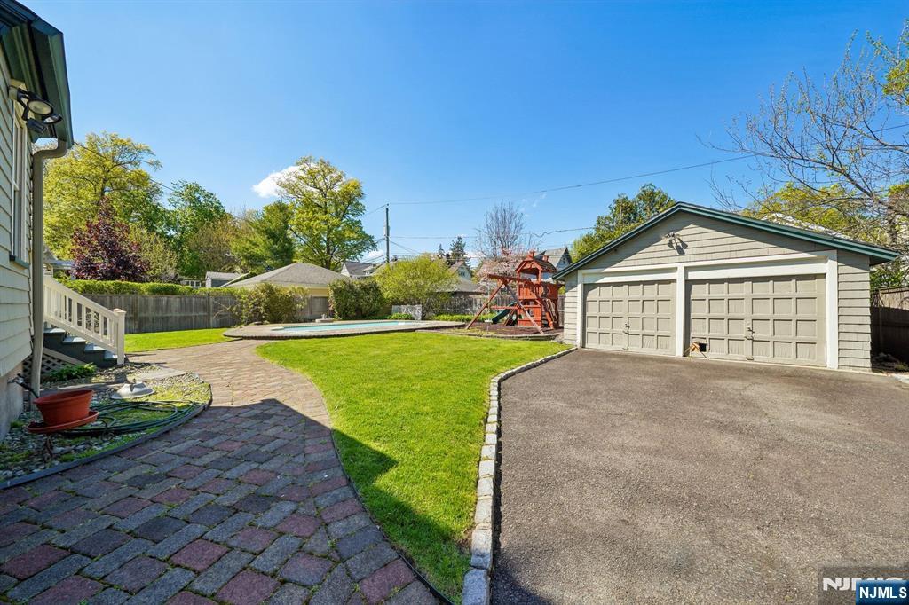 215 Inwood Avenue Montclair, NJ 07043 - Photo 49 of 50 a front view of a house with a garden and yard