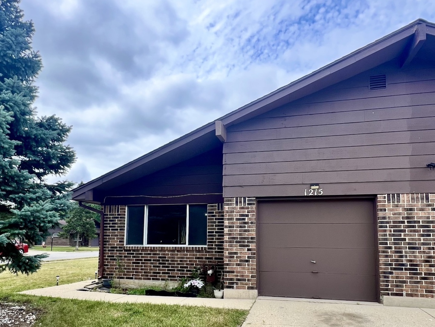 a front view of a house with garage