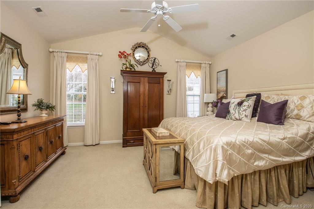 680 Amethyst Circle Fort Mill, SC 29708 - Photo 14 of 30 a spacious bedroom with a bed and a chandelier