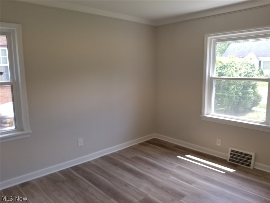 5671 Wellington Road Cleveland, OH 44124 - Photo 12 of 26 Spare room featuring wood-type flooring and plenty of natural light