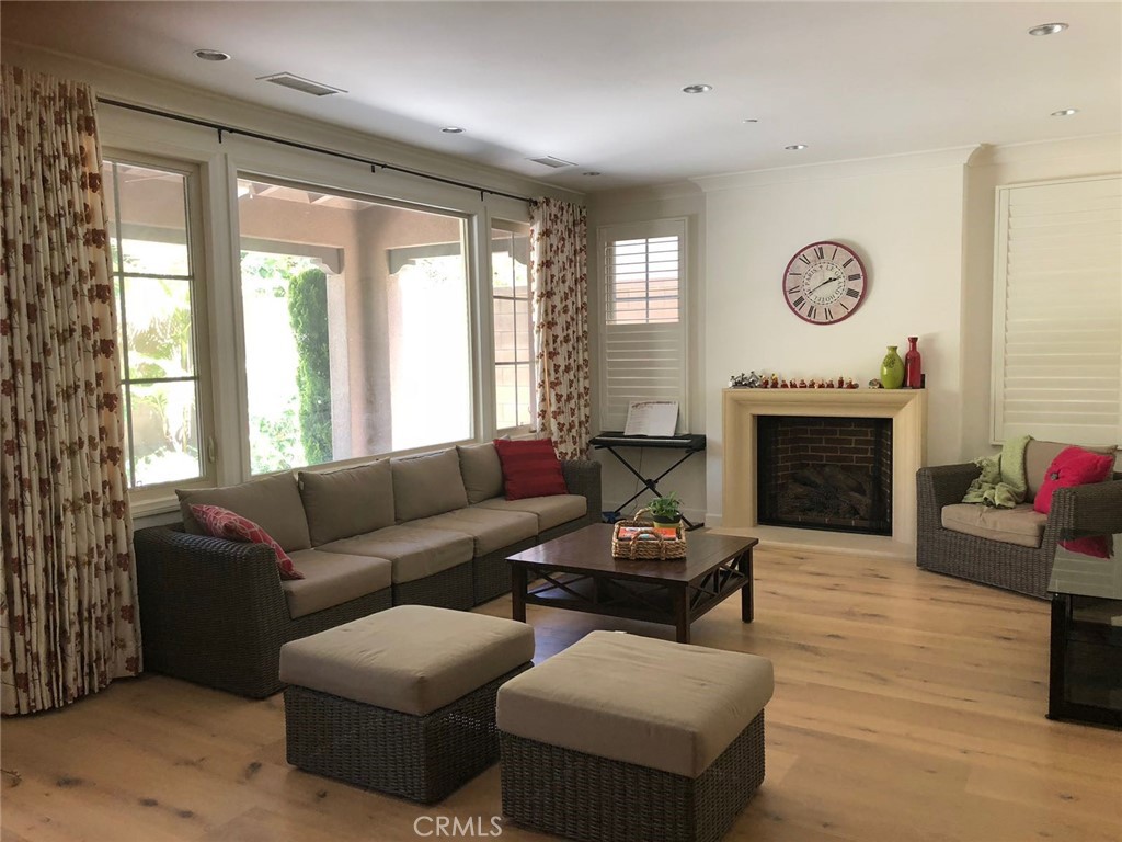 88 Lupari Irvine, CA 92618 - Photo 12 of 33 a living room with furniture a fireplace and a large window