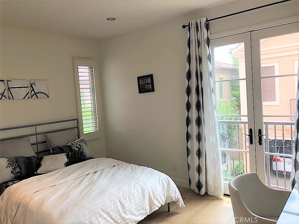 88 Lupari Irvine, CA 92618 - Photo 16 of 33 a bedroom with a bed and wooden floor