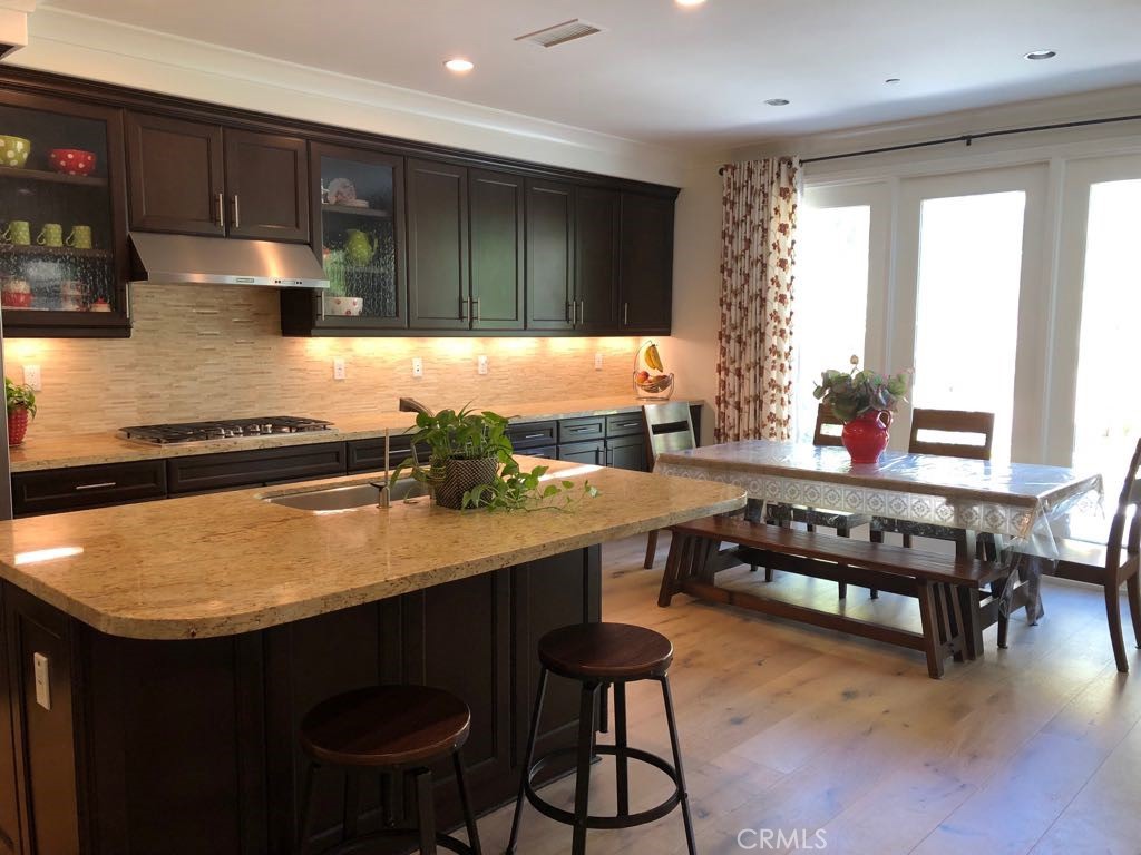 88 Lupari Irvine, CA 92618 - Photo 6 of 33 a kitchen with a table chairs sink and cabinets