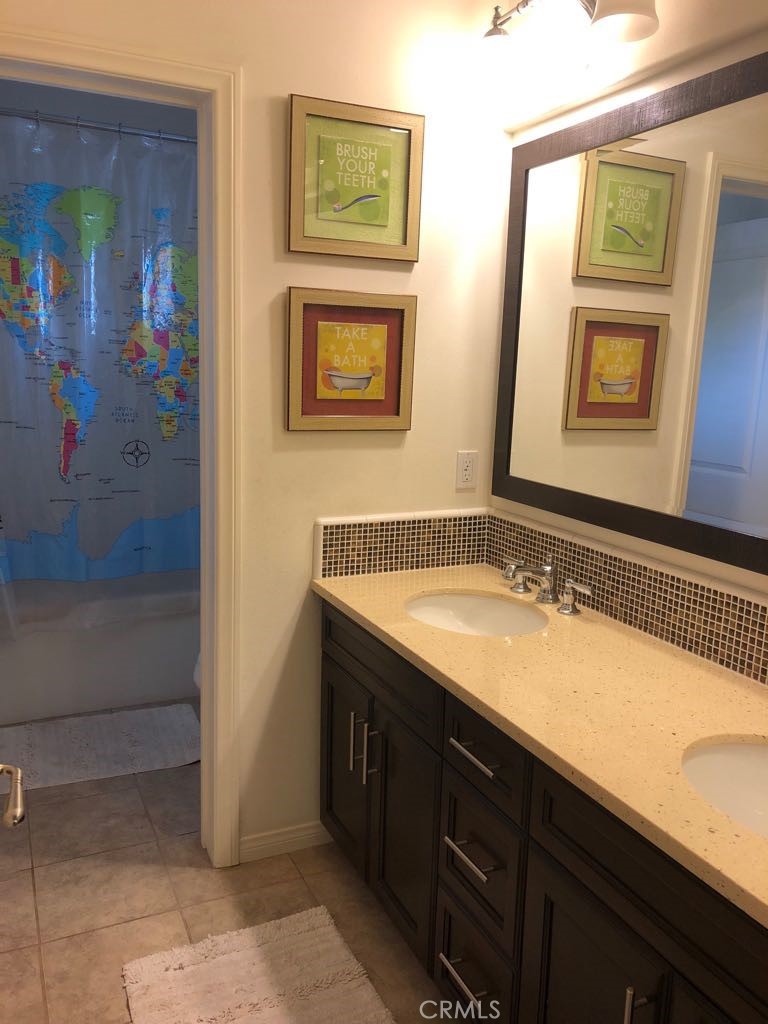 88 Lupari Irvine, CA 92618 - Photo 7 of 33 a bathroom with a granite countertop sink and a mirror