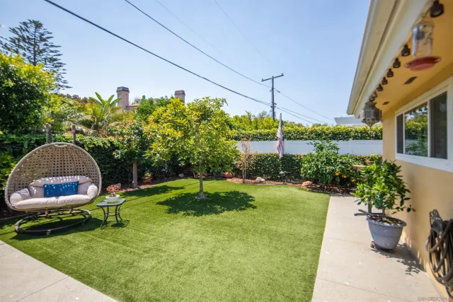 a view of backyard with outdoor seating a patio and a garden