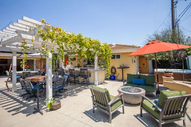a backyard of a house with yard and outdoor seating