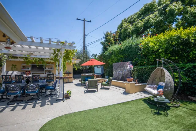 a patio with a table and chairs under an umbrella