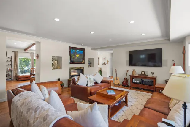 a living room with furniture a flat screen tv and a fireplace