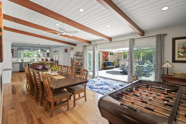 a kitchen with sink a stove and chairs