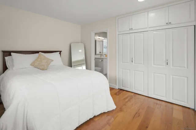 a bathroom with a toilet a sink a mirror a vanity and shower