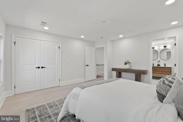 a spacious bedroom with a bed and a fireplace