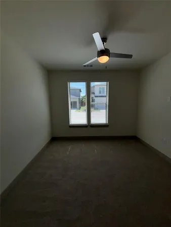 a view of a livingroom with a ceiling fan and window