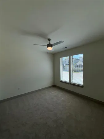 an empty room with a empty space and windows